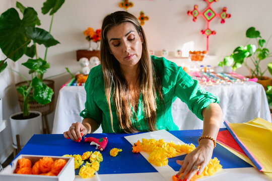 Mexican making flower arch to decorate altar