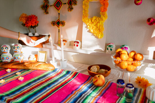 Female hand lighting candles at offering altar