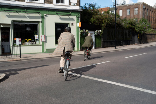 Senior and adult men cycling in the city