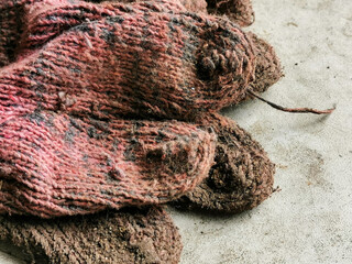 Selective focus close up image with noise effect dirty cotton hand gloves.