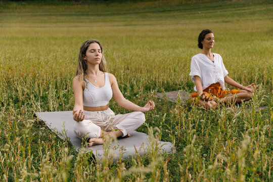 Women Meditating In Lotus Pose