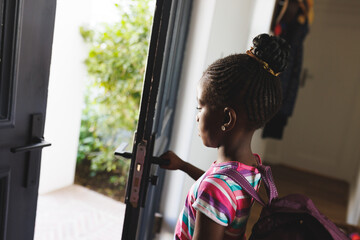 African american girl wearing backpack, leaving for school
