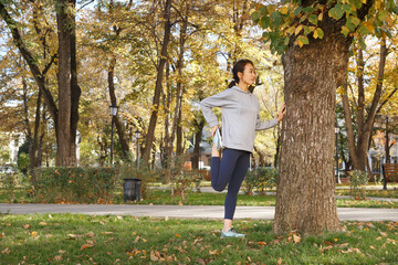 Female athlete stretching bent leg