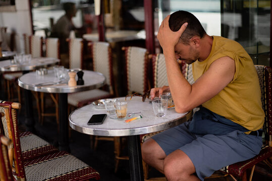 Man sitting at a typical Paris cafe 