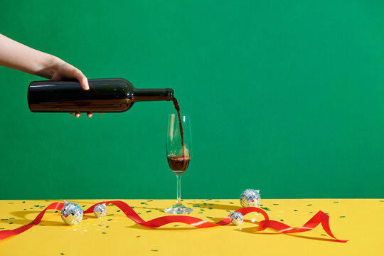 Pouring a glass of wine  in festive theme
