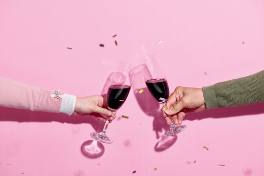 Celebration toast with wine with color streamers
