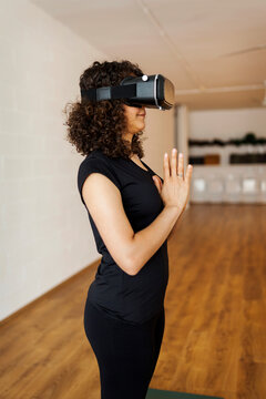 Modern woman during virtual reality yoga class