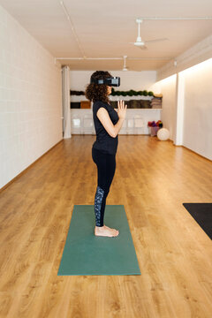 Female practicing vr yoga in studio