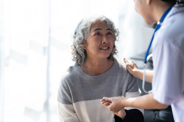 Obraz premium Young female doctor provide care medical service help support smiling old grandma at homecare medical visit.