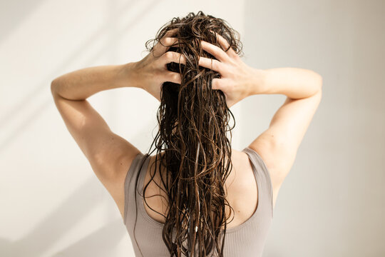 Image of wet long hair with applied beauty product 