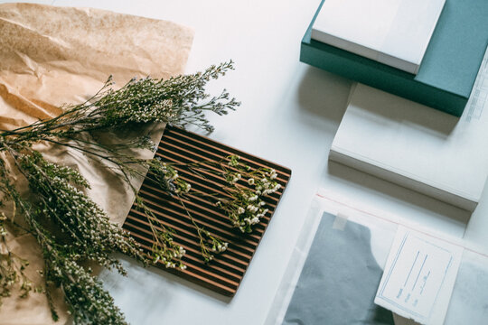 Office Table With Dried Flowers and Architectural Plans