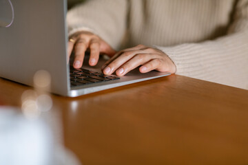 Female hands typing on laptop closeup