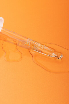 Tincture dropper on orange background