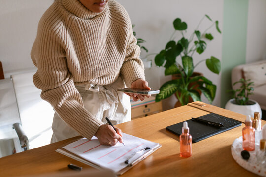 Cropped woman working standing at desk