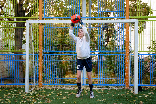 Female soccer player goalkeeper trains on the sports field