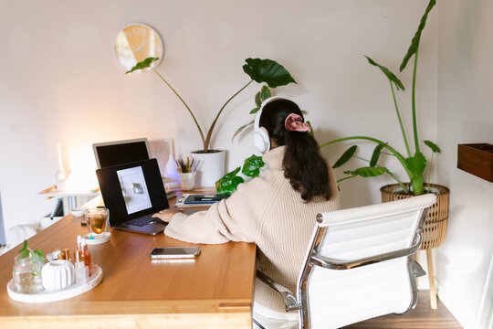 Woman with headset teleworking at natural office