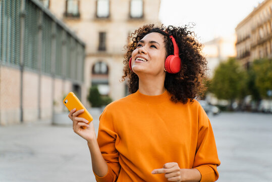 Happy Woman Listening To Music With Headphones