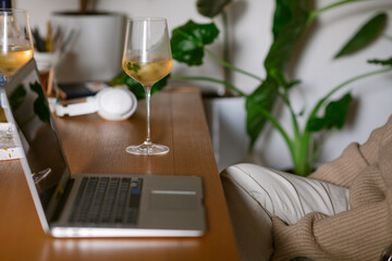Glasses with white wine on cozy desk