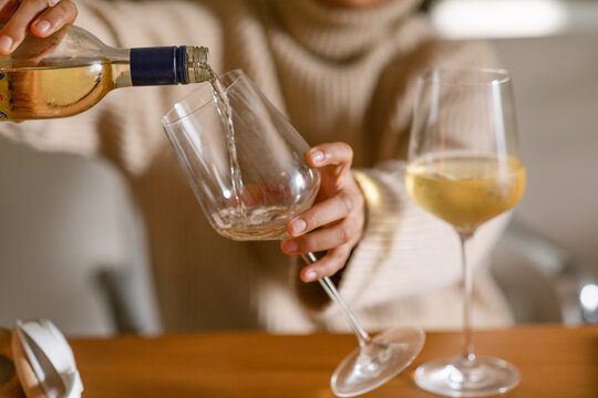 Female pouring herself a glass of wine