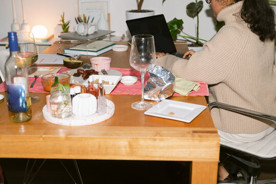 Woman working and dining in office at night