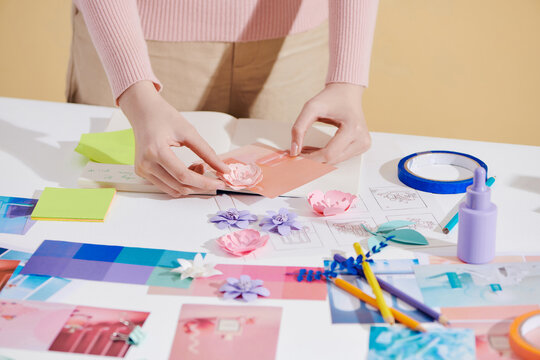 Lifestyle photography of a female art director hands arranging a set