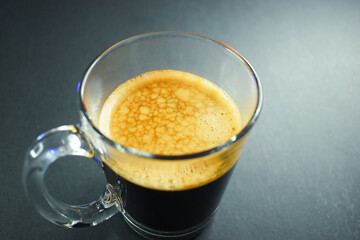hot black coffee on black table, beverage in the morning