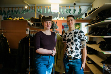 Portrait of two people in leather repair store.
