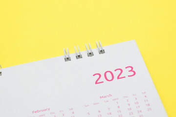 white calendar 2023 on yellow background