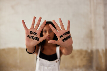 Female activist showing hands with inscriptions