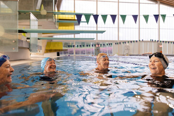 Group of women laughing at the swimming pool.