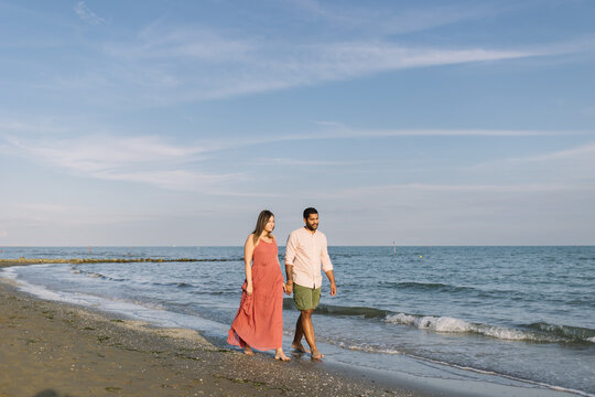 Couple Walking On The Shoreline
