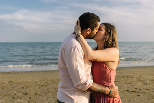 Couple Kissing At The Beach