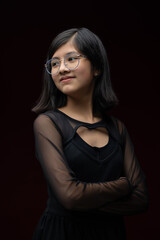 Naklejka premium 12 year old girl portrait isolated on red background wearing gla
