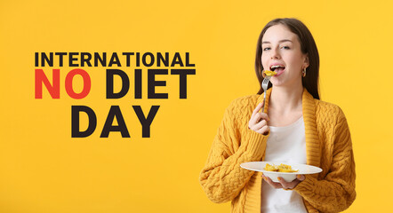 Beautiful young woman eating tasty ravioli on yellow background. International No Diet Day