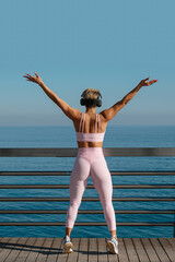 beautiful latin woman does fitness outdoors near the beach