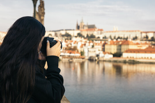 Tourist with camera photographing the city of Prague