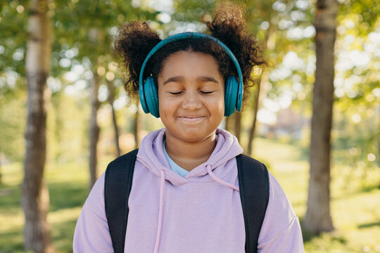 Black girl in headphones enjoying music