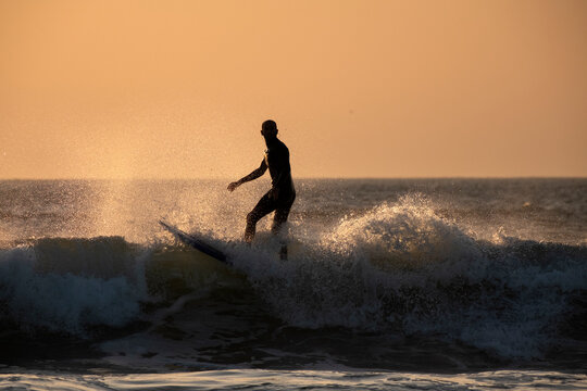 Surfing with a sunset