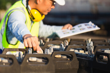 Mechanical worker checking of the battery storage system, Engineer man in waistcoats and hardhats with documents inspecting construction site