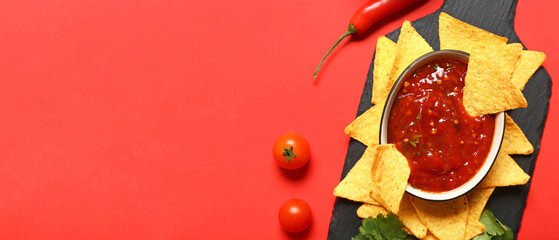 Tasty nachos and sauce on red background with space for text, top view