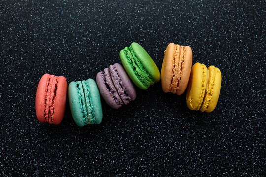 Bright colourful macaroons on a dark background