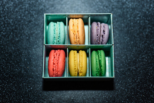 Bright colourful macaroons on a dark background