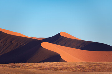 Detail of a sand dune in Namib desert, with blue and clean sky, Africa