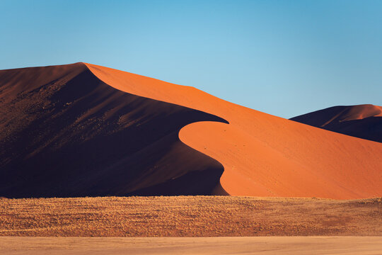 Detail of a sand dune in Namib desert, with blue and clean sky, Africa