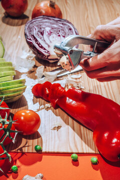 Chefs crushing garlic with crusher