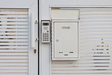 Modern intercom on white door