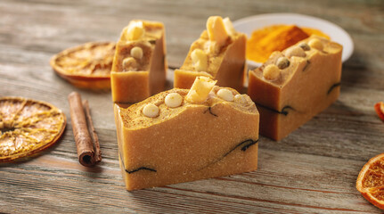 Natural orange soap on the wooden background. Concept of making and using organic eco soap and cosmetics