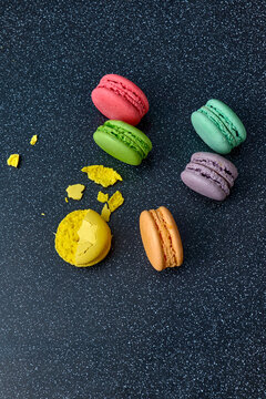 Bright colourful macaroons on a dark background