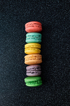 Bright colourful macaroons on a dark background
