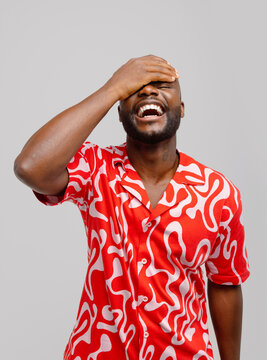 Cheerful black man laughing with eyes closed